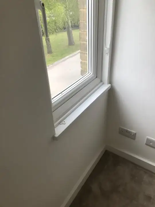 Side-hinged window with sill slightly proud of the wall