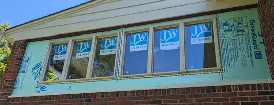 windows are taped to foam insulation, bottom of window is taped, improper head flashing