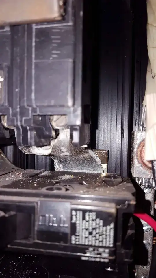 White deposits on hot bus bar under main breaker in electrical panel