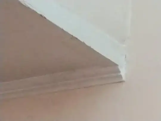 Picture of junction over stairwell between lower ceiling, adjacent wall, and wall above steps