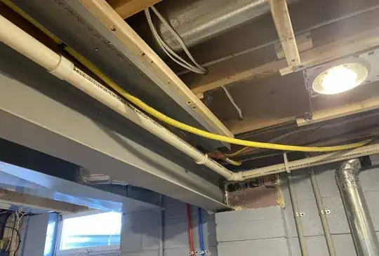 I need the CSST line to follow the path of the white PVC drain pipe.