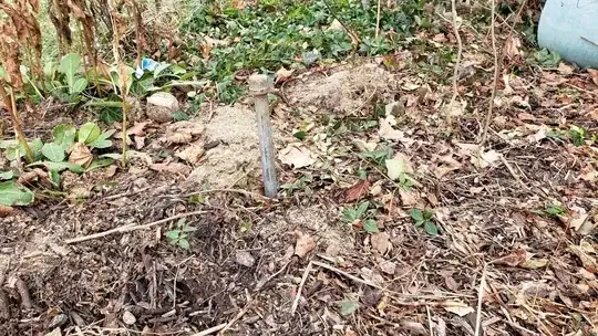 second capped off metal pipe, no hand visible