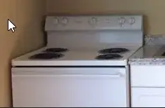 range with controls and dials at the back of the cooking area 