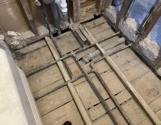 bathroom floor with exposed plumbing