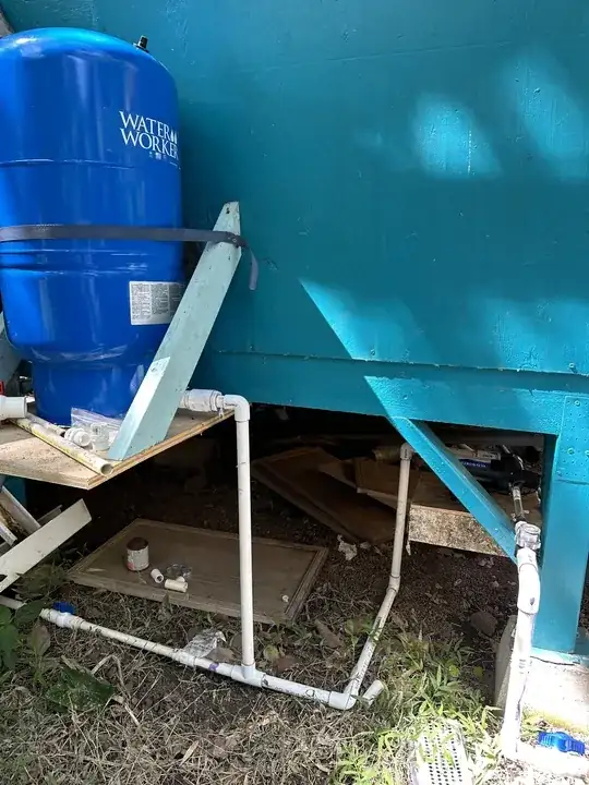Image shows RV pump with pipe going into pressure tank then towards house