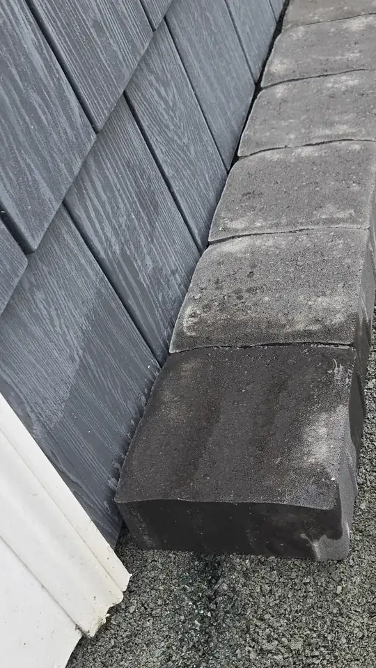 pavers above bottom of viny siding