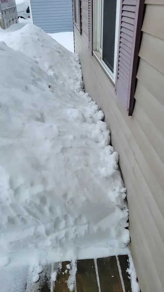 snow piled against house