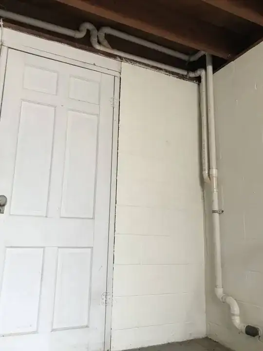 Strange bend and split in sump pump drain pipe