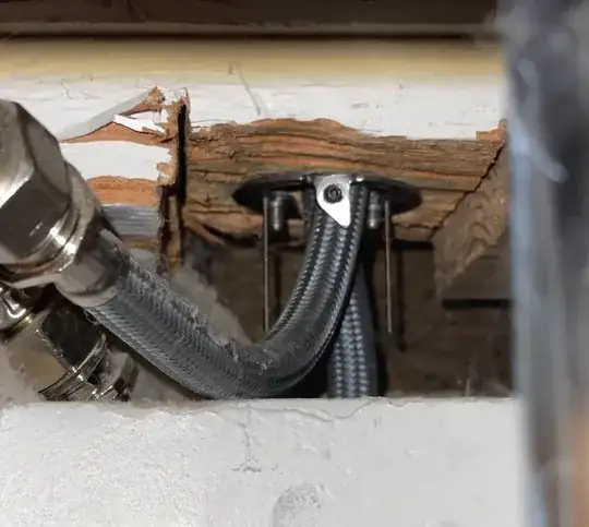 water lines headed over drywall and into a ring with two large and two thin threaded rods