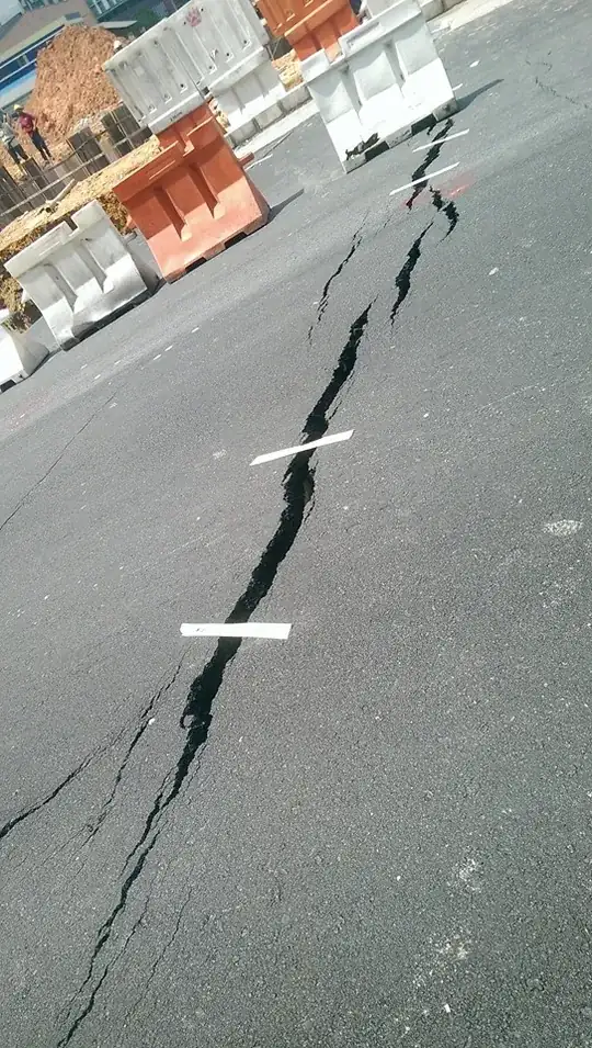 masking tape over road crack during road work