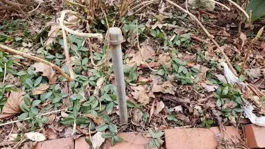 capped off metal pipe, no hand visible