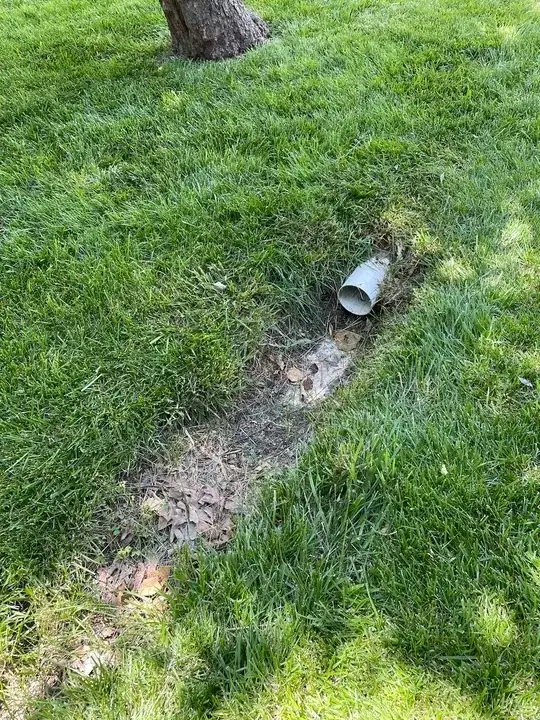 hole in the yard caused by running water from rain down spout
