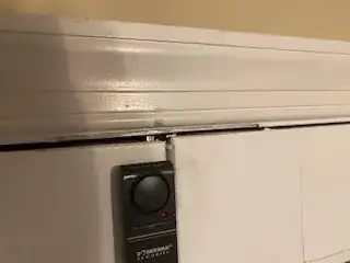 Photo of latch pin extending upward into the door frame