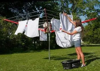 Woman hanging clothes on outdoor rack
