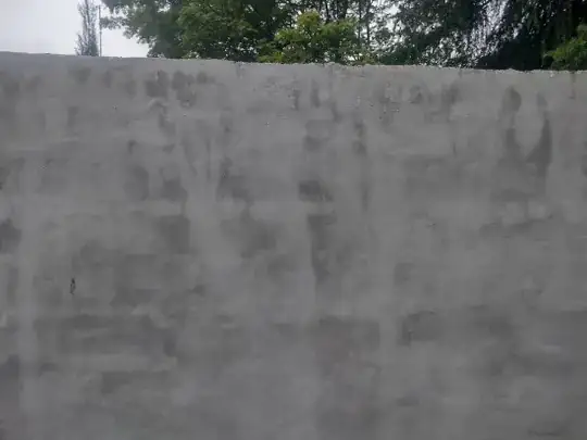 Picture of rendered wall with dark patches