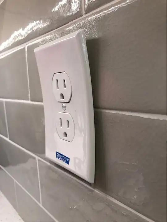 Warped outlet cover on wall