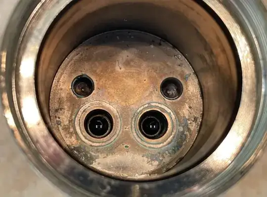interior of the faucet with two holes for water inlet, and two indentations for aligning the cartridge