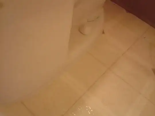 toilet which sits flat on the floor, grouted with sanded cement grout