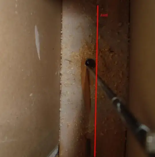 Looking down inside wall, drill bit visible
