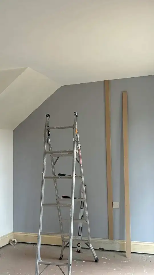 left side of wall showing the diagonal ceiling area under stairs