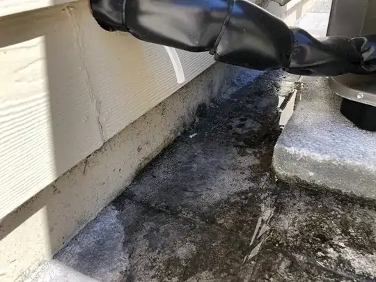 Outdoor heat pump unit with water pooling next to it