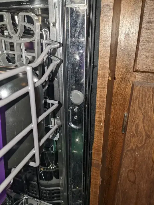 Side-mount screw hole shown with gray, plastic cover in place.