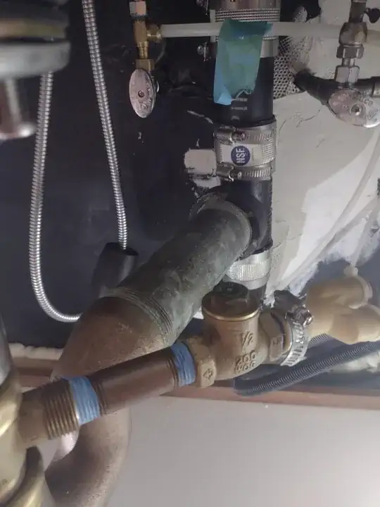 another angle under the sink, showing the rest of the pipe the trap connects to