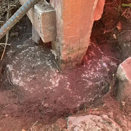 rotten base of fence post