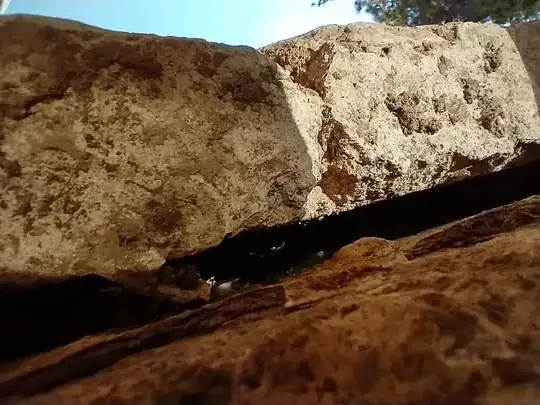 gap between wall and facade as seen looking skyward from pit shown in photo 4