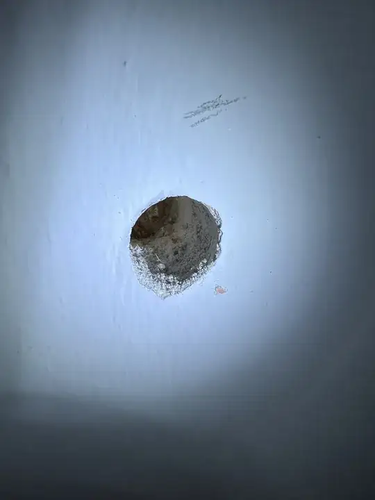 hole drilled into wall, 1 inch to stud