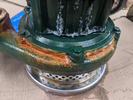 Water pump showing rust around the lower part of the housing (close-up)