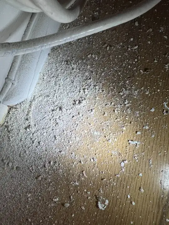 debris from wall from drilling, on floor