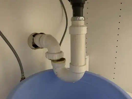 picture of a p-trap connected to sink tailpipe but not lining up with drain