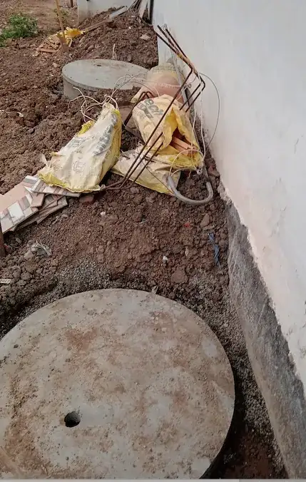 Two 3 feet by 3 feet dry wells on the other of building