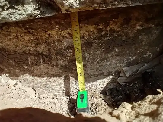 tape measure shown extending up into gap behind facade