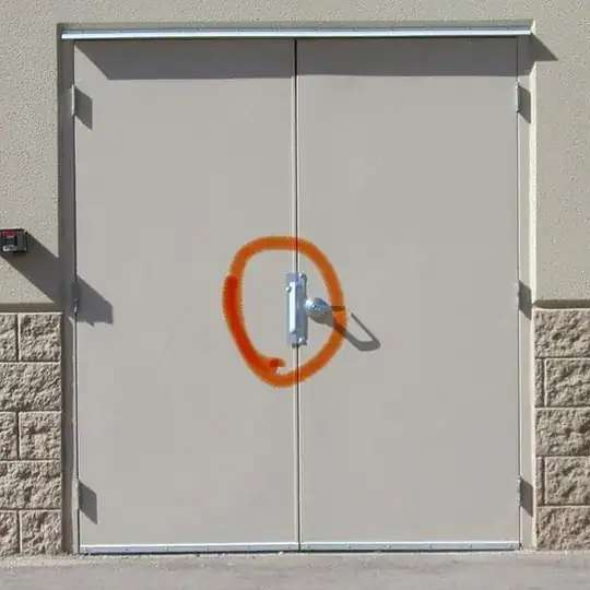 double doors with metal plate covering latch circled