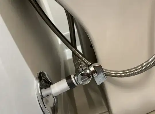 rear of toilet near the wall