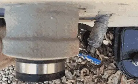 Image from the top looking down on a spigot. The spigot is bent to the left, and bends more as the wrench applies pressure.