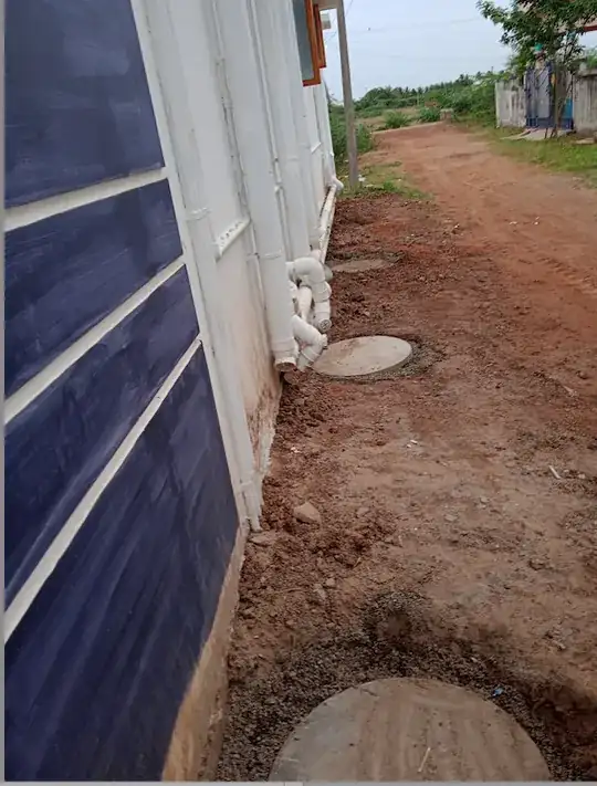 Four 2 feet by 2 feet  dry wells on one side of building