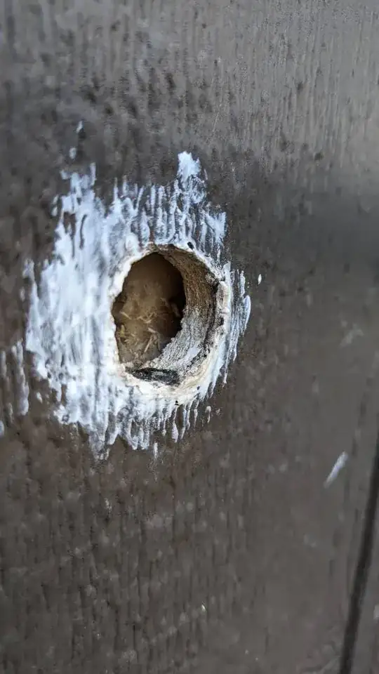 Hole drilled into the south wall.