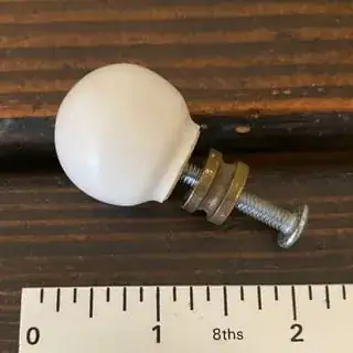 Porcelain pull with screw and spacer attached.