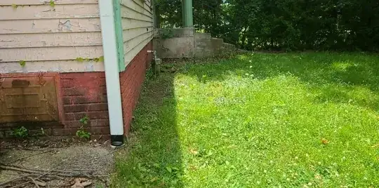 Front and back of house look roughly like this, seems like an easier case, but am I right that I can just pack some clay soil down against the house to make sure the negative-grade bits abutting the house are positive grade?