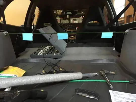 The inside of my car with some paracord, a reference line and some junk.