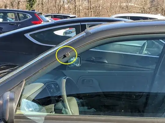 picture of old car window with rubber tab sticking out