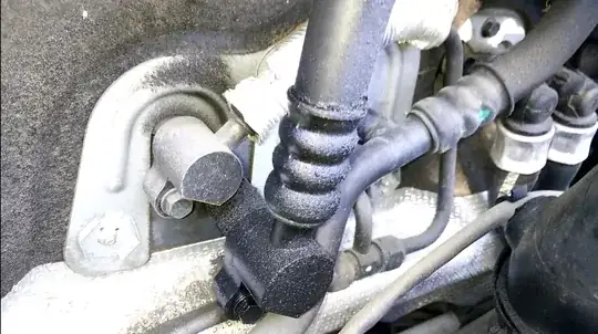 Close up on the hose attached to something passing through the firewall