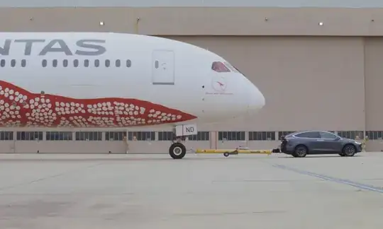 Tesla towing a Boeing Dreamliner. Photo credit Quantas.