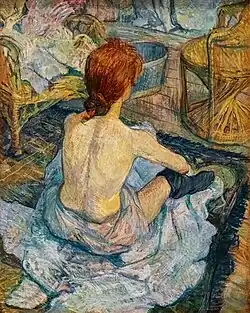 A thin woman's back and hair are prominent. She faces away from the viewer and has on only a towel and socks.