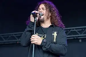 Manzi performing with The Sweet in 2023.