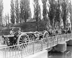 A 60 Pounder with a limber towed by a horse-team.  Its barrel has been pulled back to rest on its trail for transport.