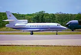Trijet passenger plane on runway, with nose of another aircraft in background